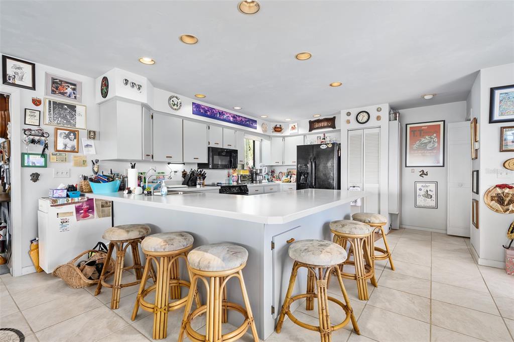 14 Marsh Court Ponce Inlet, FL 32127 - Photo 11 of 64 a kitchen with stainless steel appliances kitchen island granite countertop a refrigerator and cabinets