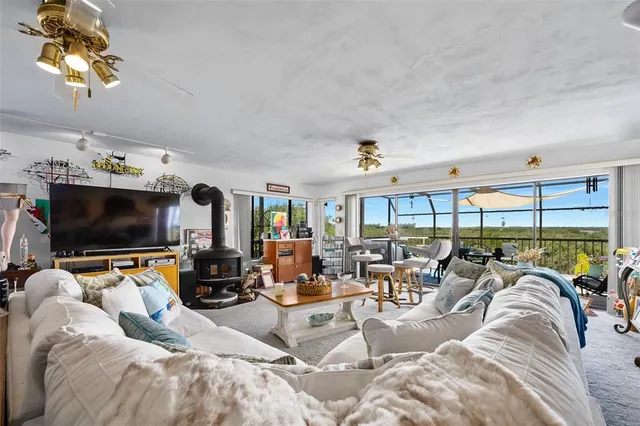 a spacious bedroom with a bed and a chandelier