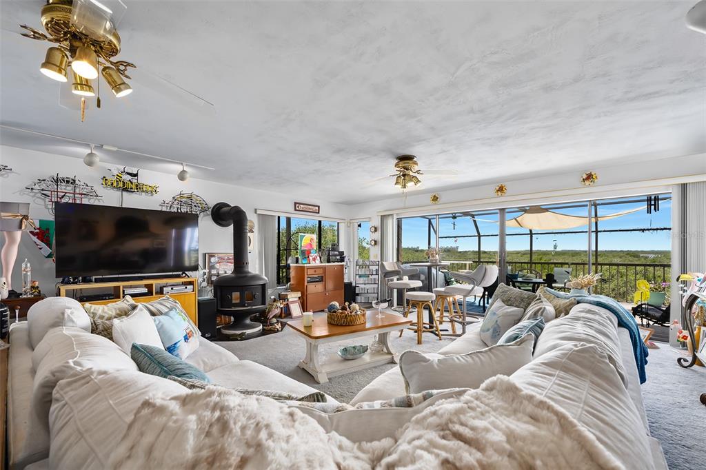 14 Marsh Court Ponce Inlet, FL 32127 - Photo 16 of 64 a living room with furniture a flat screen tv and floor to ceiling window
