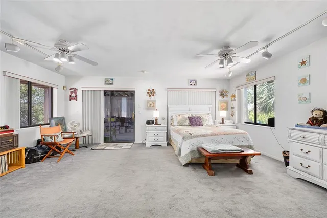 a bed room with furniture and a flat screen tv