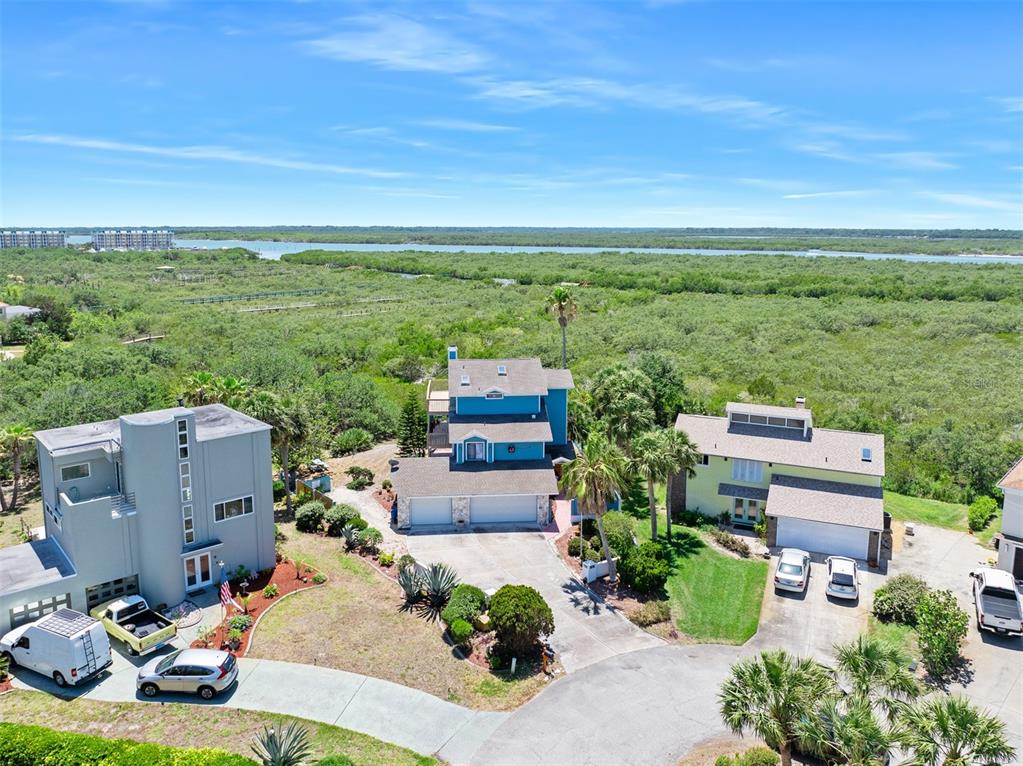 14 Marsh Court Ponce Inlet, FL 32127 - Photo 2 of 64 an aerial view of a house with garden space and ocean view