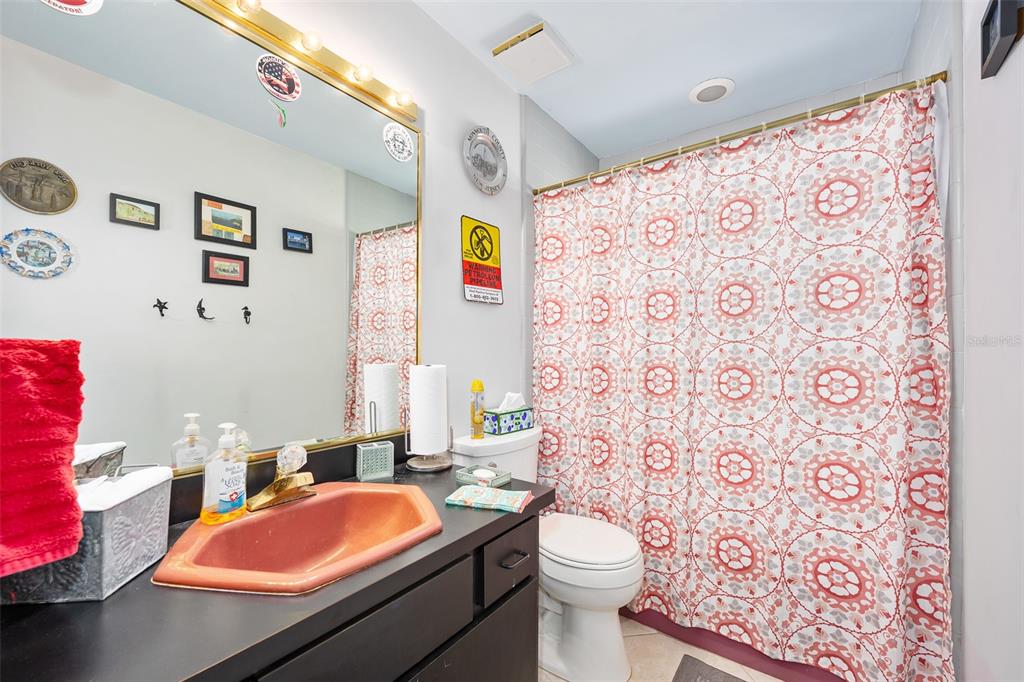 14 Marsh Court Ponce Inlet, FL 32127 - Photo 24 of 64 a bathroom with a toilet a sink and a shower curtain