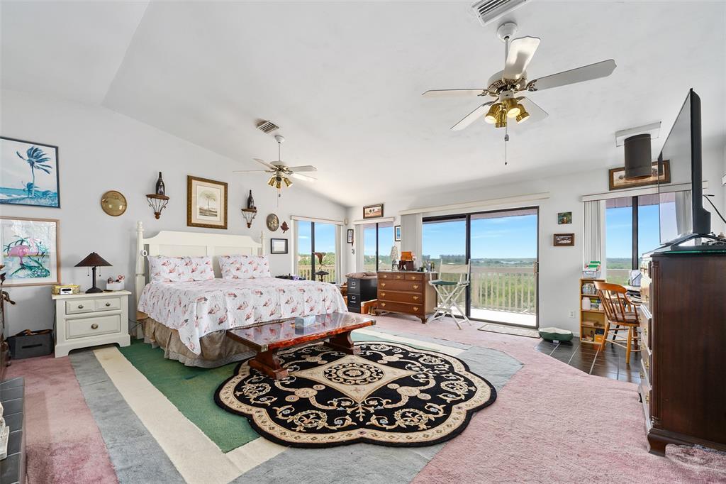 14 Marsh Court Ponce Inlet, FL 32127 - Photo 29 of 68 a bed room with furniture and a flat screen tv
