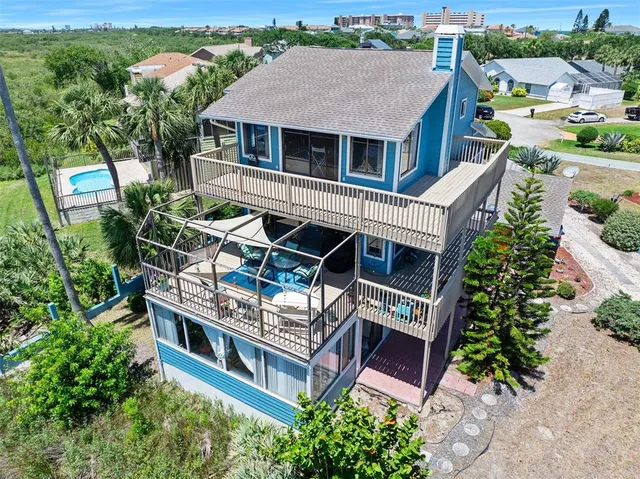 an aerial view of a house with balcony and garden