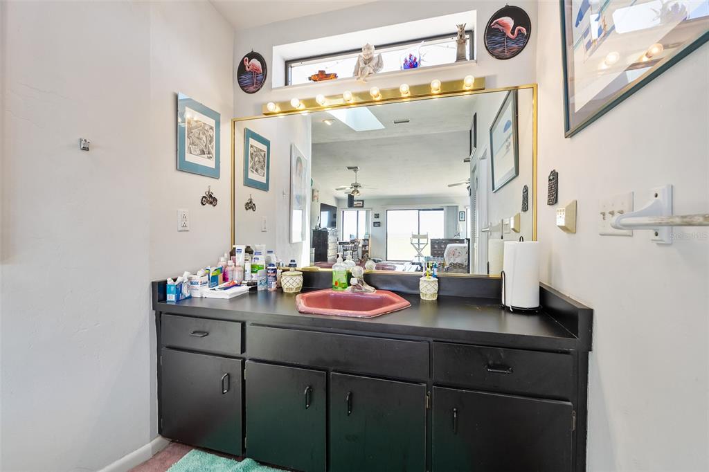 14 Marsh Court Ponce Inlet, FL 32127 - Photo 46 of 64 a bathroom with a sink vanity and a mirror