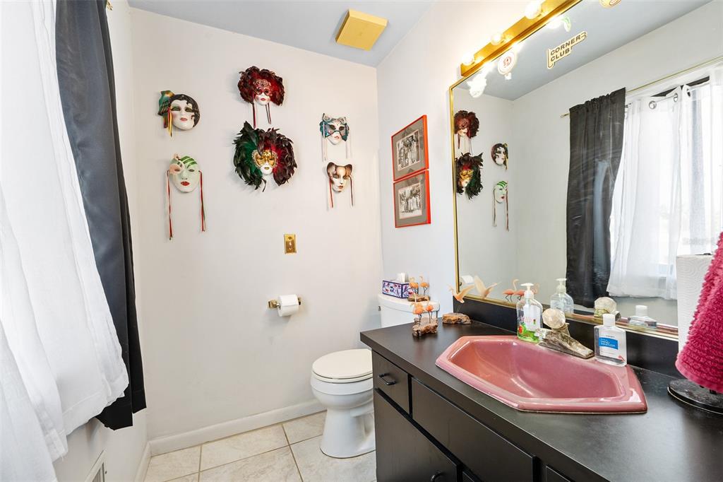 14 Marsh Court Ponce Inlet, FL 32127 - Photo 55 of 68 a bathroom with a sink mirror vanity and toilet