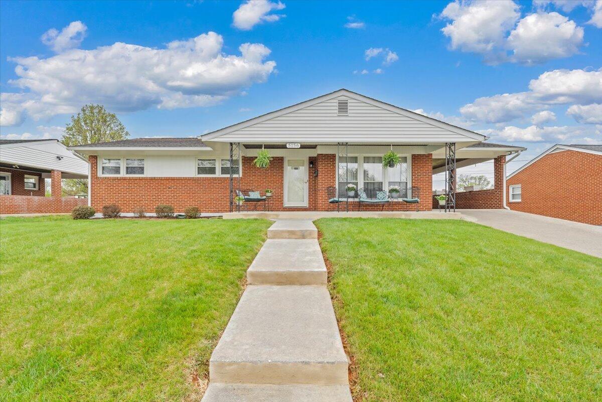 5156 Hazelridge Road Northwest Roanoke, VA 24012 - Photo 1 of 30 a front view of a house with a yard and potted plants