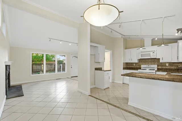 a view of an empty room with a fireplace and a window