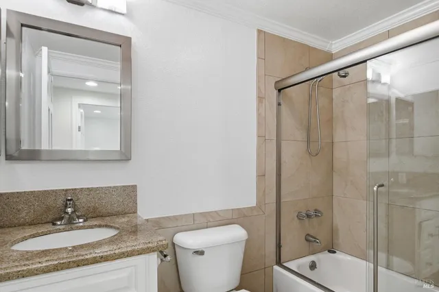 a kitchen with white cabinets a sink and appliances