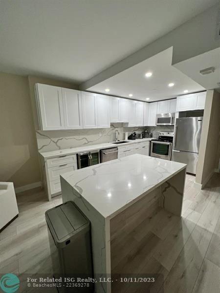 2301 Collins Avenue, Unit 327 Miami Beach, FL 33139 - Photo 11 of 11 a kitchen with stainless steel appliances granite countertop a sink stove and refrigerator