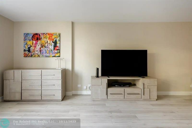 2301 Collins Avenue, Unit 327 Miami Beach, FL 33139 - Photo 5 of 11 a living room with furniture and a flat screen tv