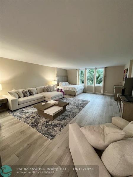 2301 Collins Avenue, Unit 327 Miami Beach, FL 33139 - Photo 7 of 11 a living room with furniture and a flat screen tv