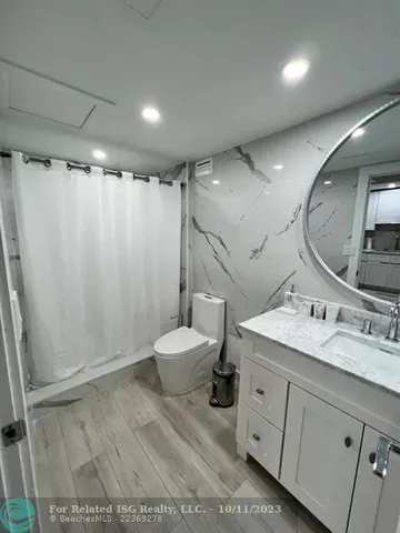 a large bathroom with a sink a toilet and shower