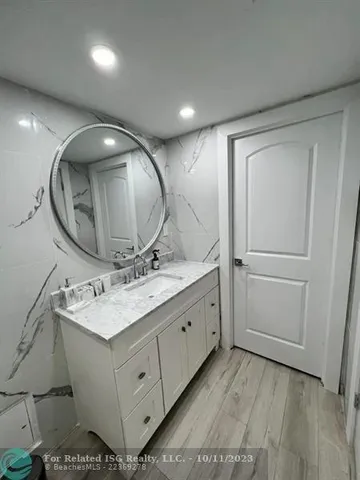 a bathroom with a sink mirror and vanity