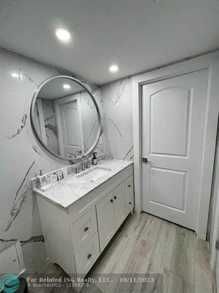 2301 Collins Avenue, Unit 327 Miami Beach, FL 33139 - Photo 9 of 11 a bathroom with a sink mirror and vanity