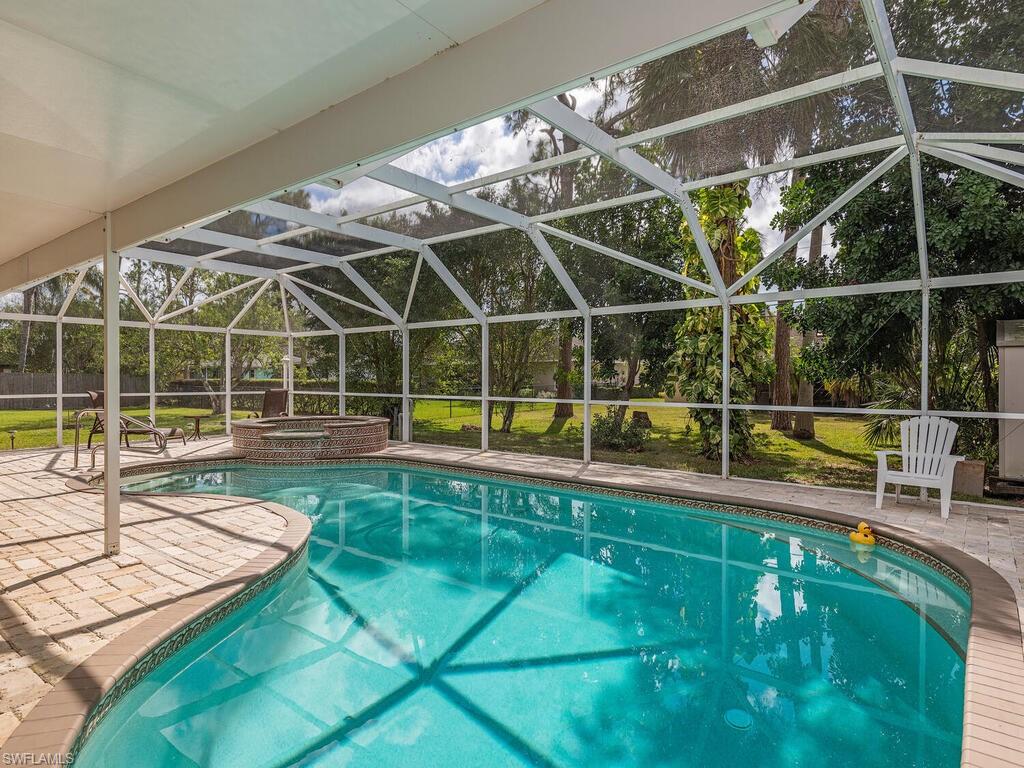 a view of a swimming pool with lounge chair