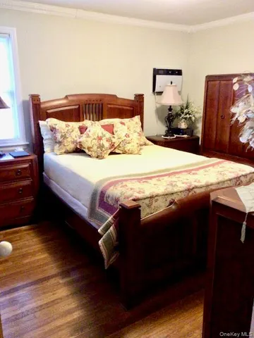 a bedroom with a bed and dresser