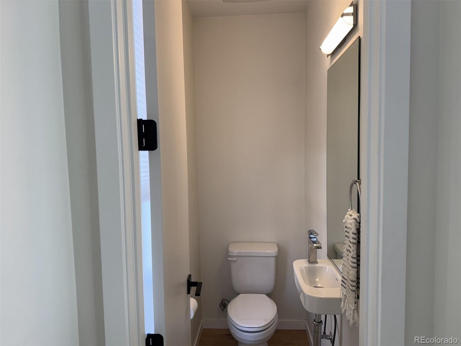 910 West 40th Avenue Denver, CO 80211 - Photo 11 of 33 a white toilet sitting next to a bathroom sink