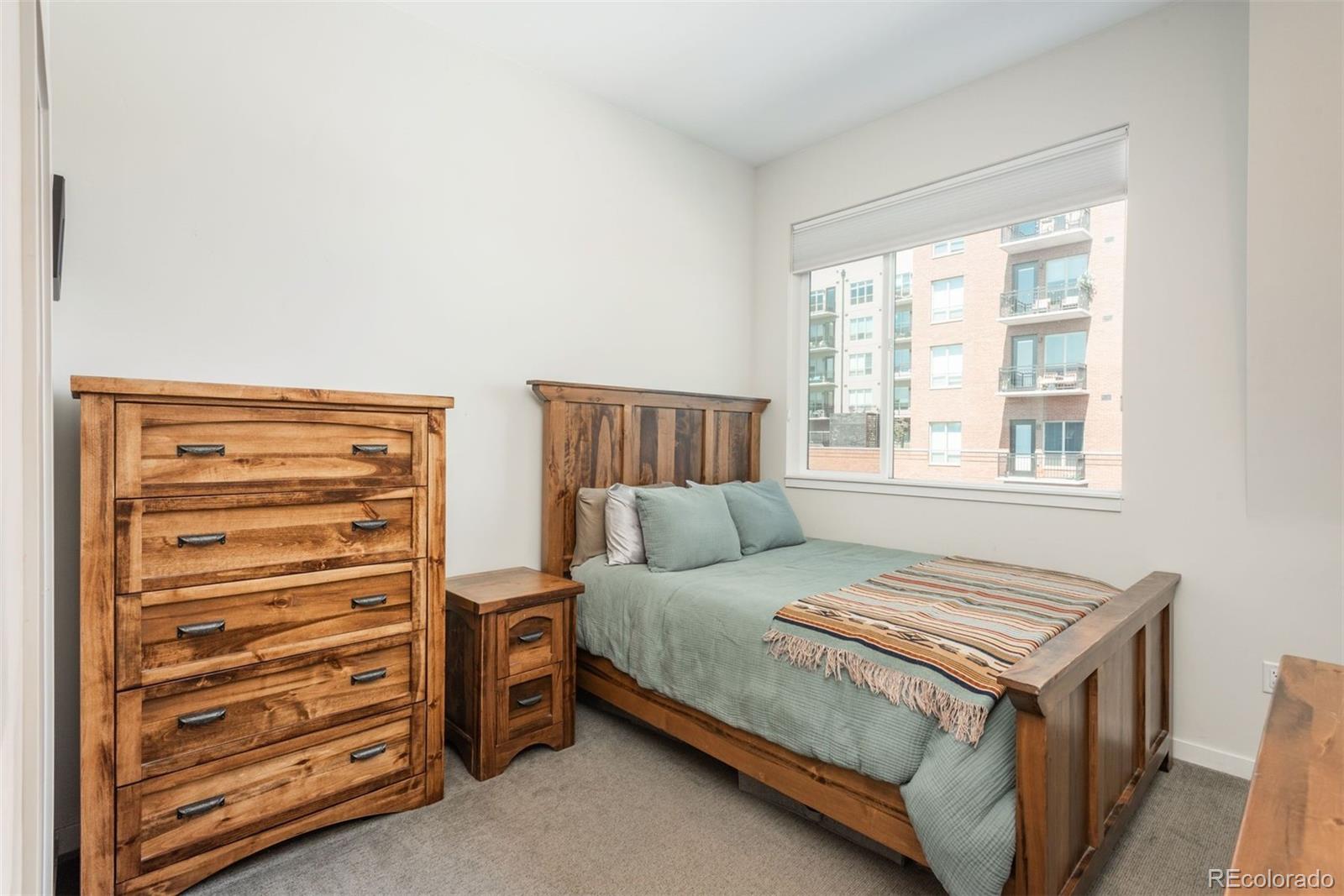 910 West 40th Avenue Denver, CO 80211 - Photo 12 of 33 a bedroom with a bed and a dresser