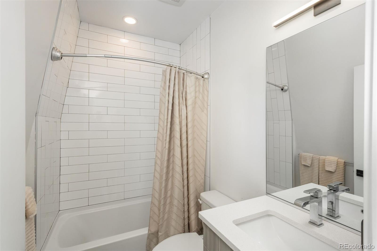 910 West 40th Avenue Denver, CO 80211 - Photo 16 of 33 a bathroom with a sink a toilet and shower