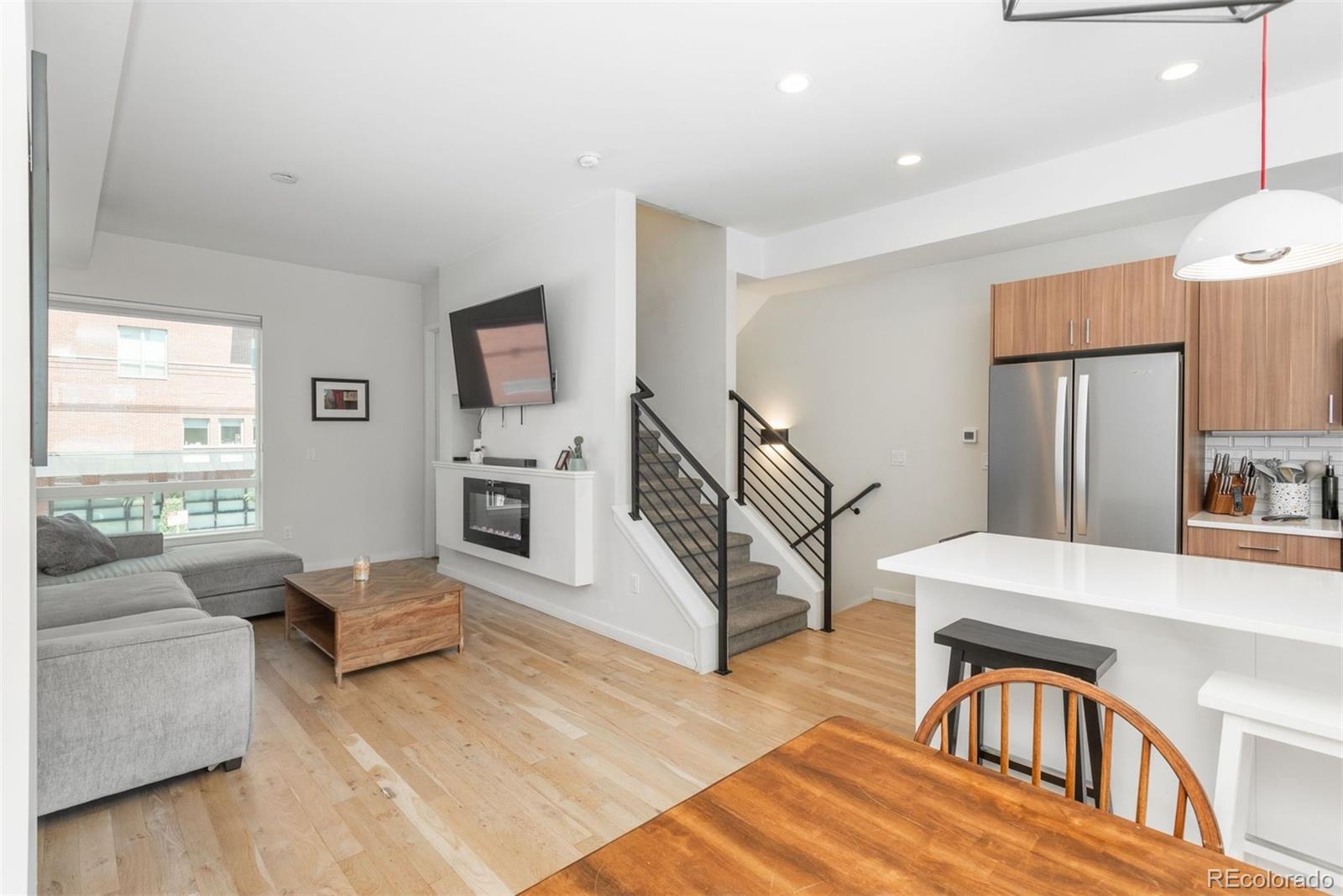 910 West 40th Avenue Denver, CO 80211 - Photo 3 of 33 a living room with furniture and a flat screen tv