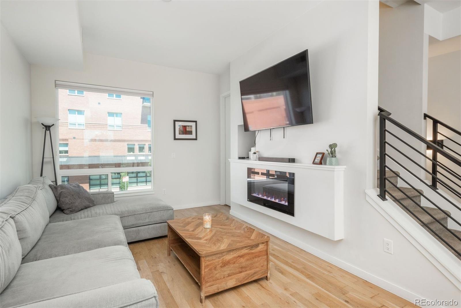 910 West 40th Avenue Denver, CO 80211 - Photo 8 of 33 a living room with furniture wooden floor and a flat screen tv