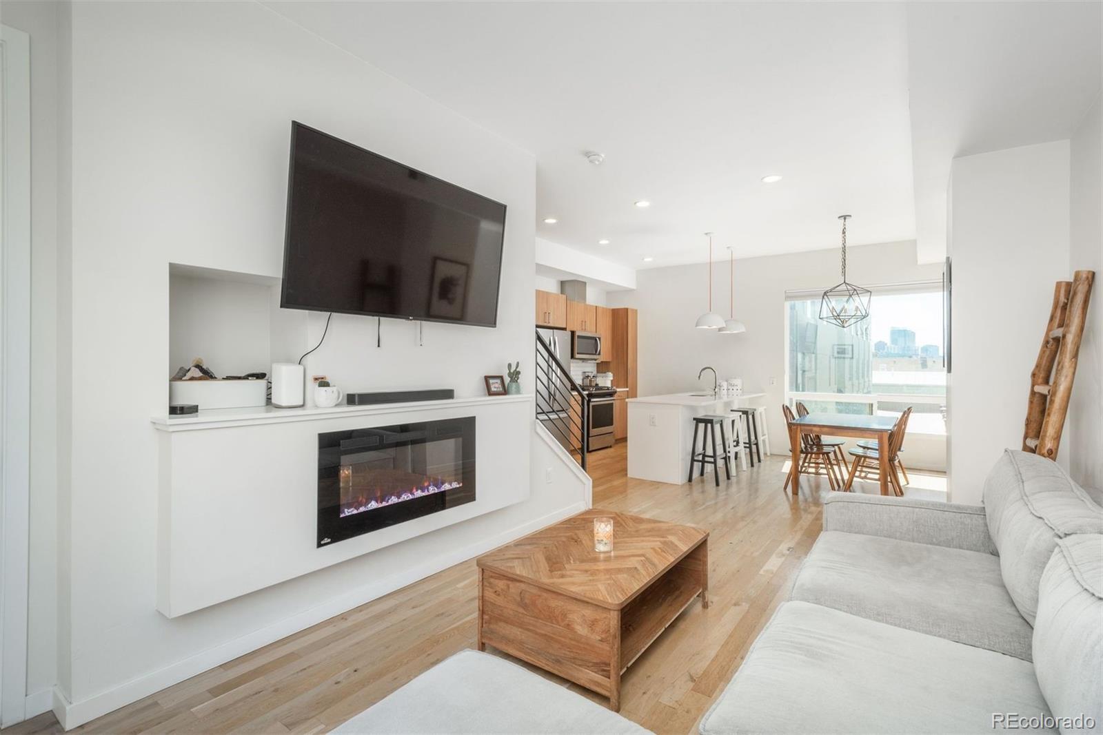 910 West 40th Avenue Denver, CO 80211 - Photo 10 of 33 a living room with furniture a fireplace and a flat screen tv
