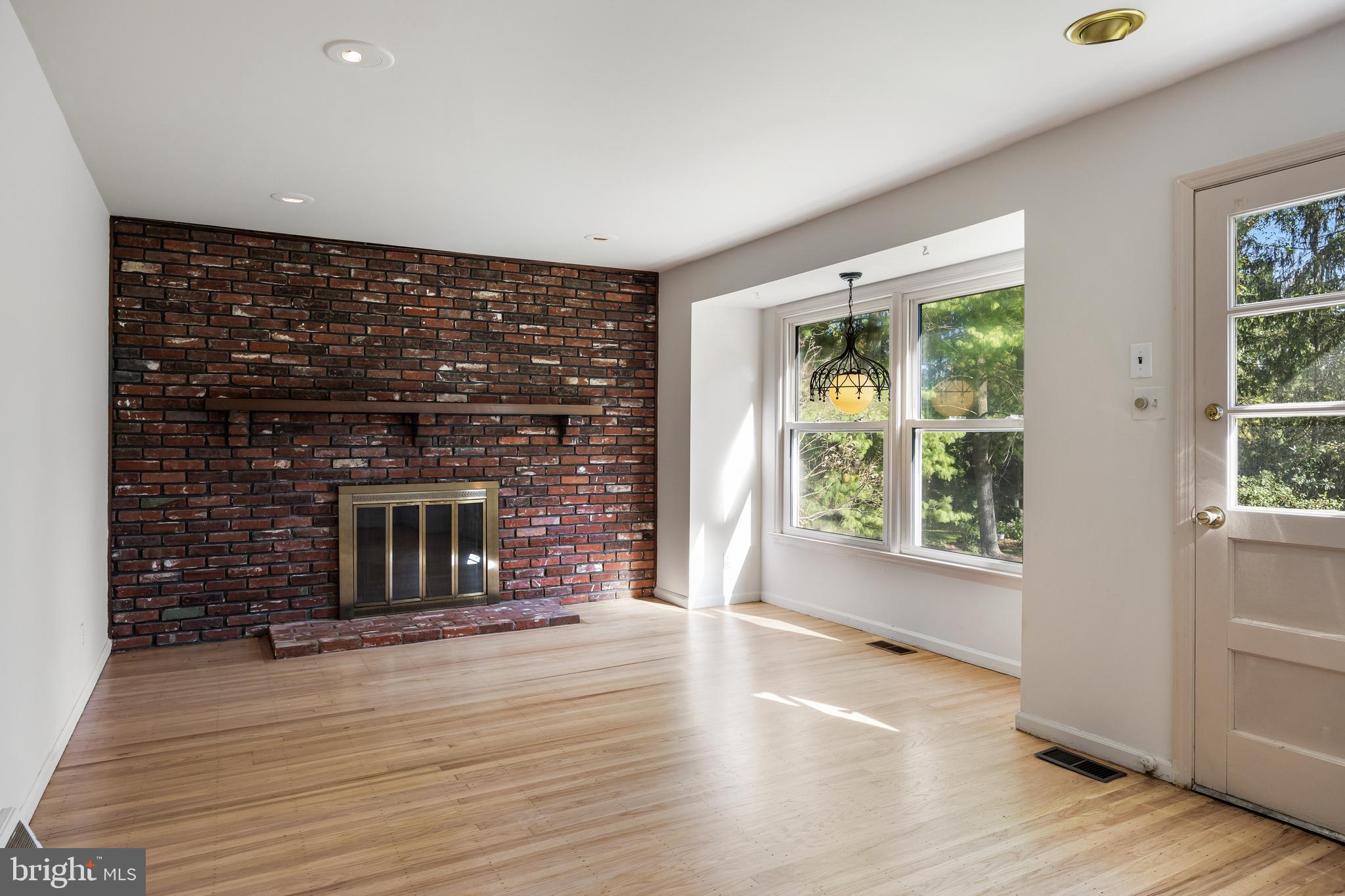 602 Wellfleet Road Cinnaminson, NJ 08077 - Photo 11 of 35 an empty room with wooden floor and a fireplace