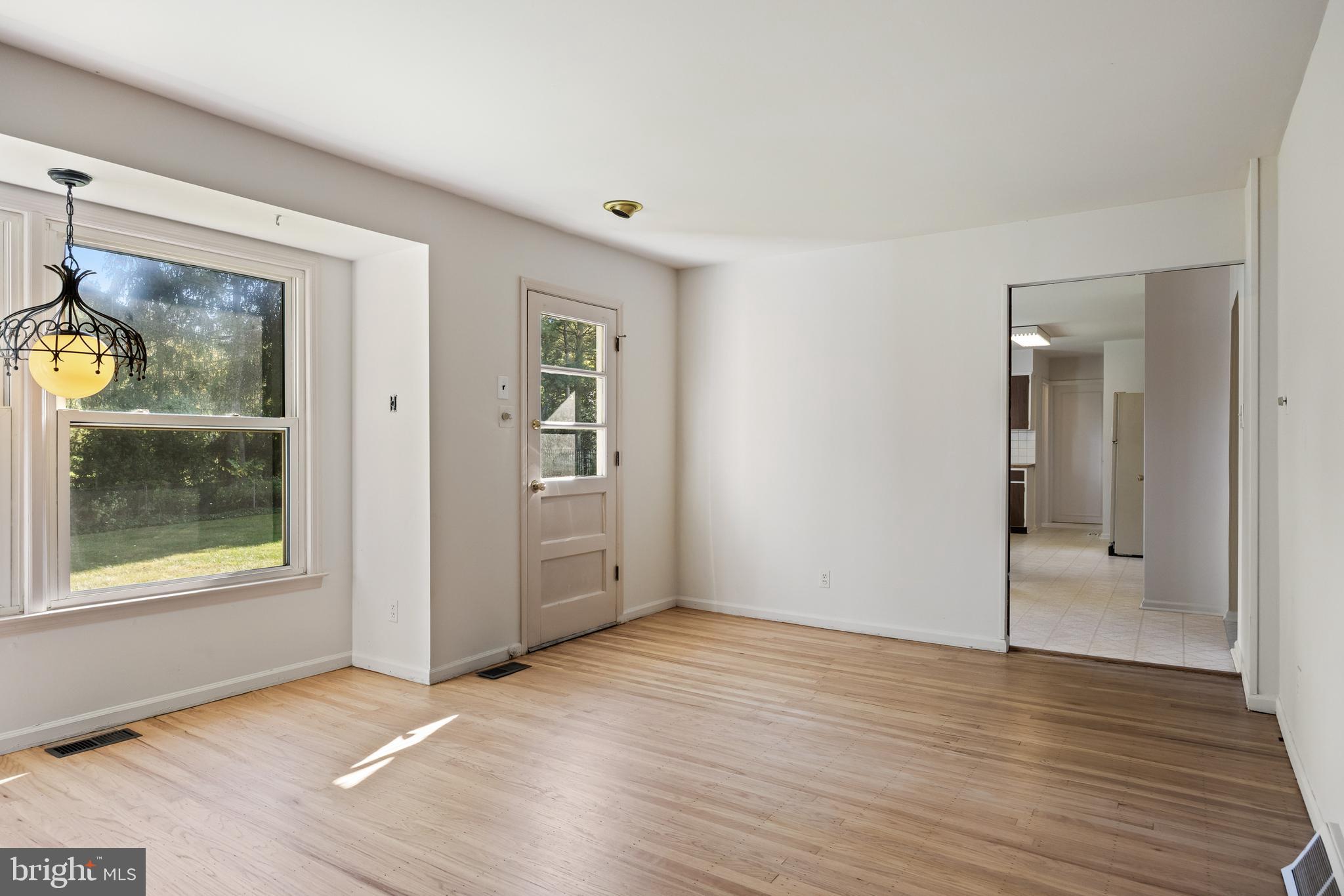 602 Wellfleet Road Cinnaminson, NJ 08077 - Photo 14 of 35 an empty room with wooden floor and windows