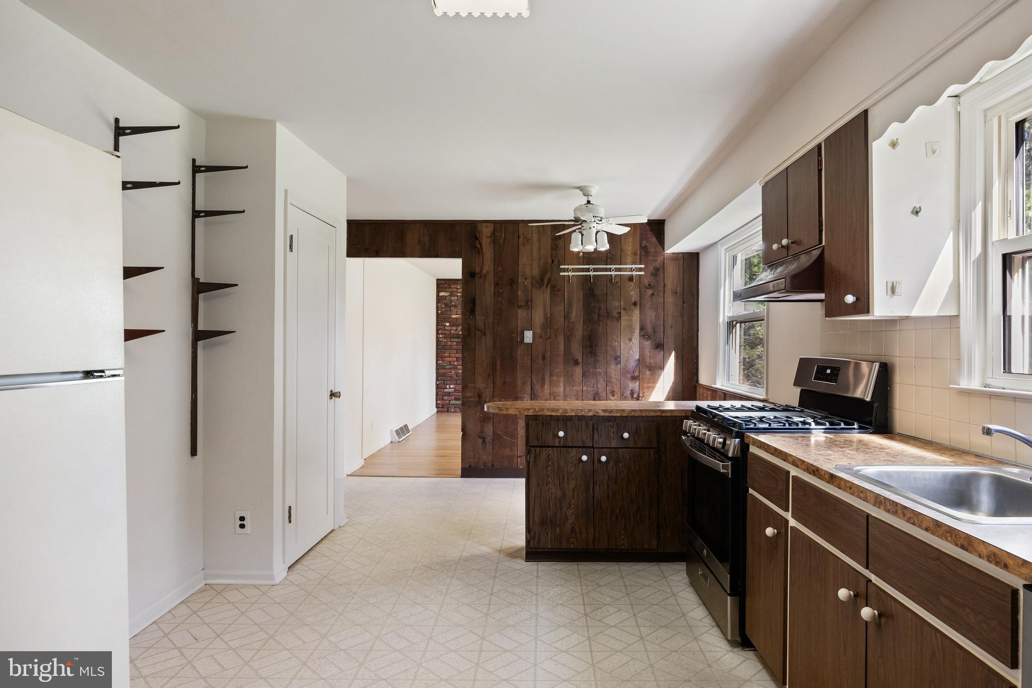 602 Wellfleet Road Cinnaminson, NJ 08077 - Photo 18 of 35 a kitchen with stainless steel appliances granite countertop a refrigerator a sink dishwasher and white cabinets with wooden floor