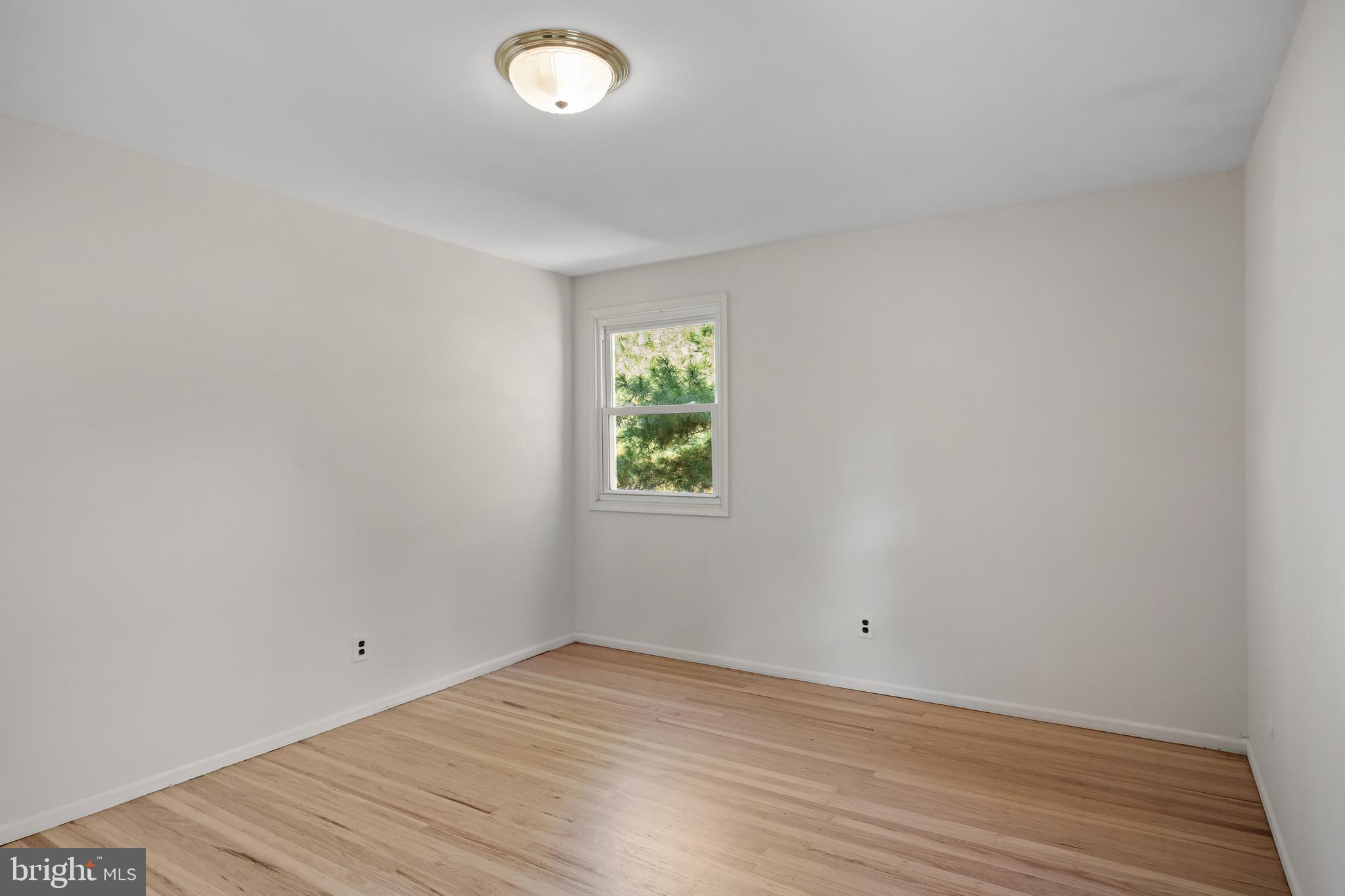 602 Wellfleet Road Cinnaminson, NJ 08077 - Photo 25 of 35 an empty room with wooden floor and windows