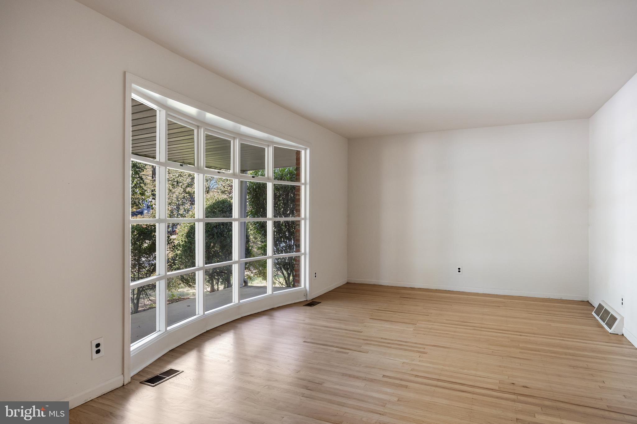 602 Wellfleet Road Cinnaminson, NJ 08077 - Photo 7 of 35 an empty room with wooden floor and windows