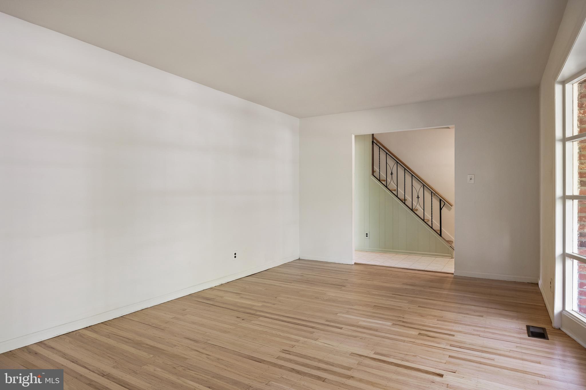 602 Wellfleet Road Cinnaminson, NJ 08077 - Photo 9 of 35 a view of an empty room with wooden floor and a window