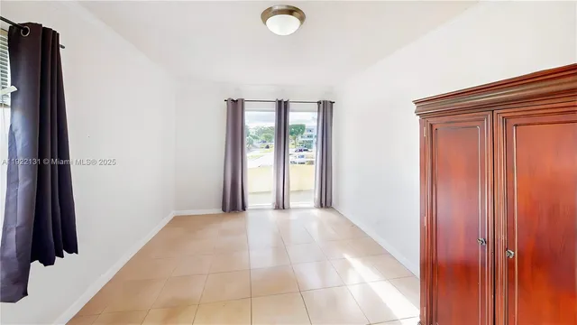 a bedroom with a bed and a flat tv screen