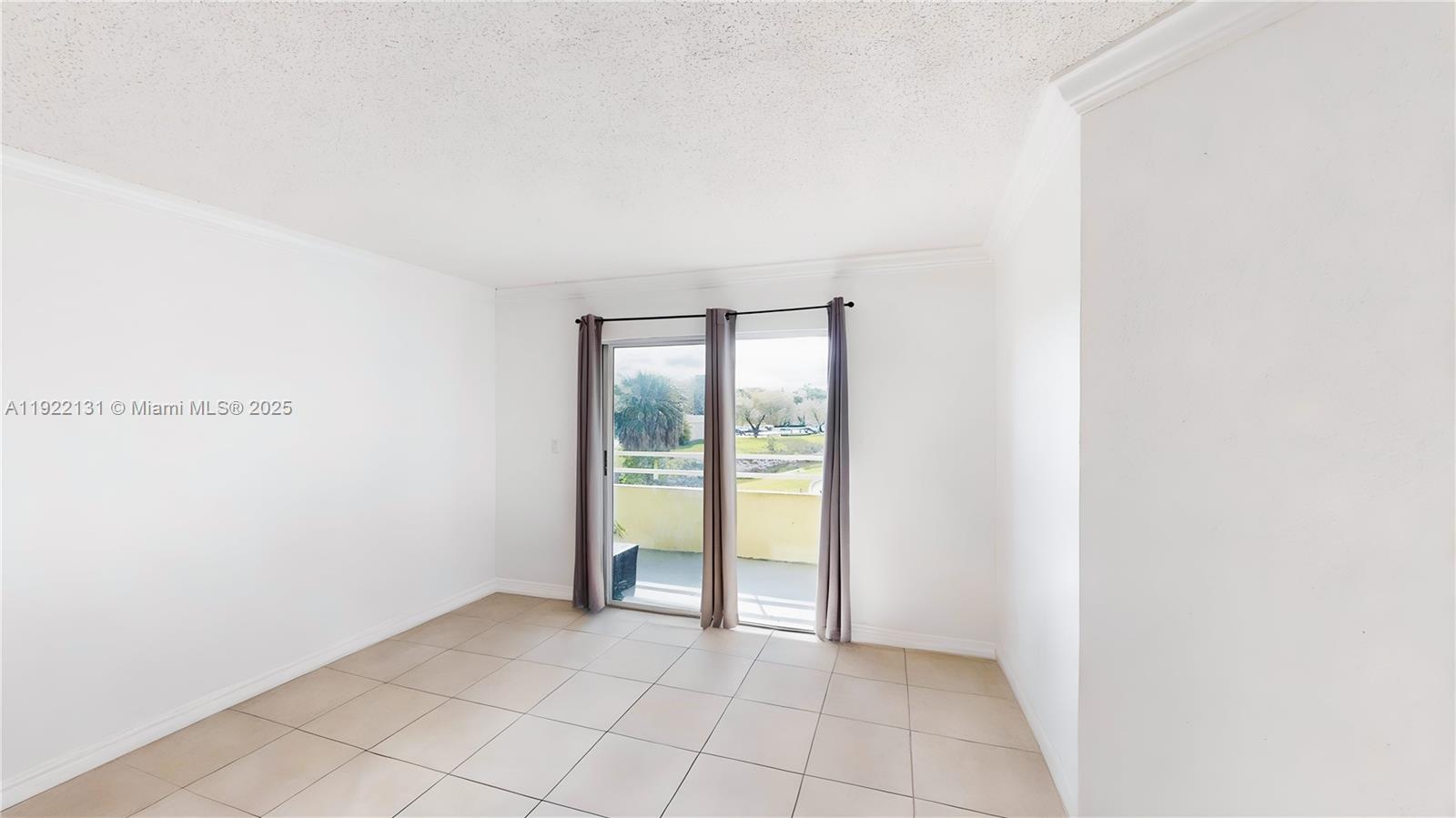 10765 Southwest 108th Avenue, Unit 208 Miami, FL 33176 - Photo 6 of 45 a view of an empty room with a window