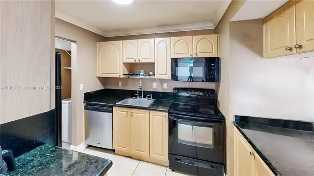 a kitchen with granite countertop a stove and a sink
