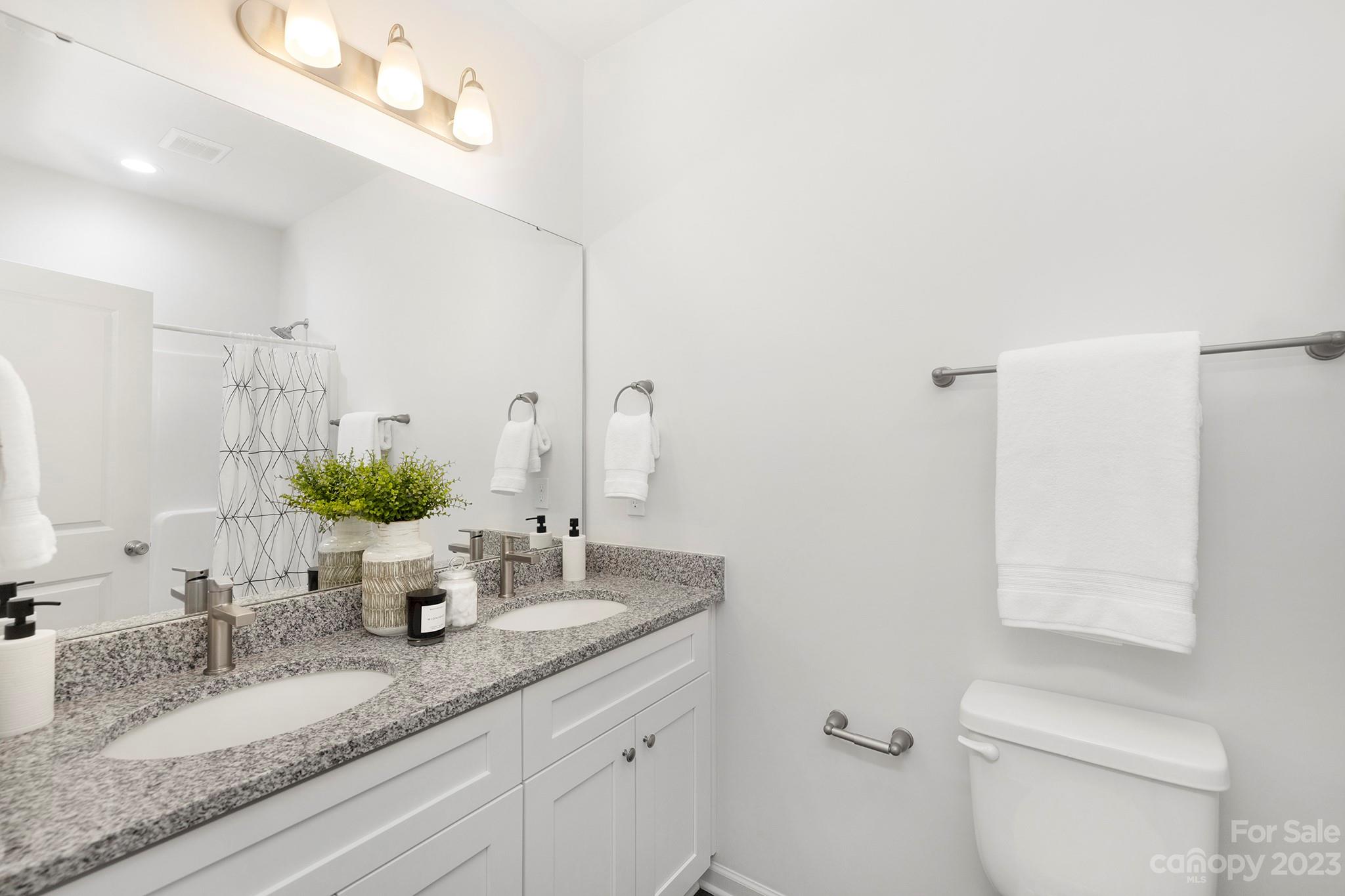 8725 Mt Holly Road Charlotte, NC 28214 - Photo 15 of 19 a bathroom with a granite countertop sink mirror and toilet