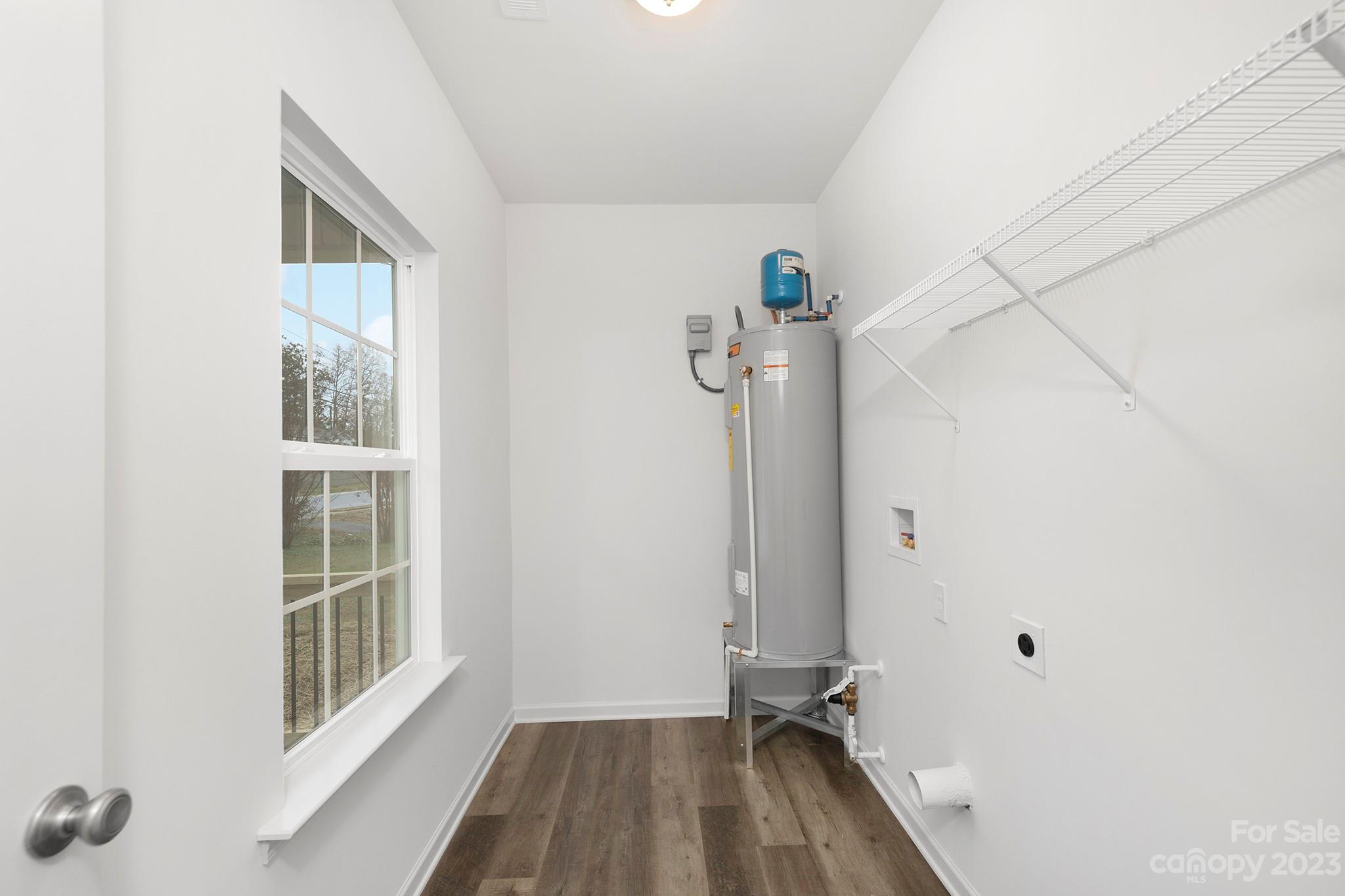 8725 Mt Holly Road Charlotte, NC 28214 - Photo 16 of 19 a view of a livingroom with wooden floor and a window