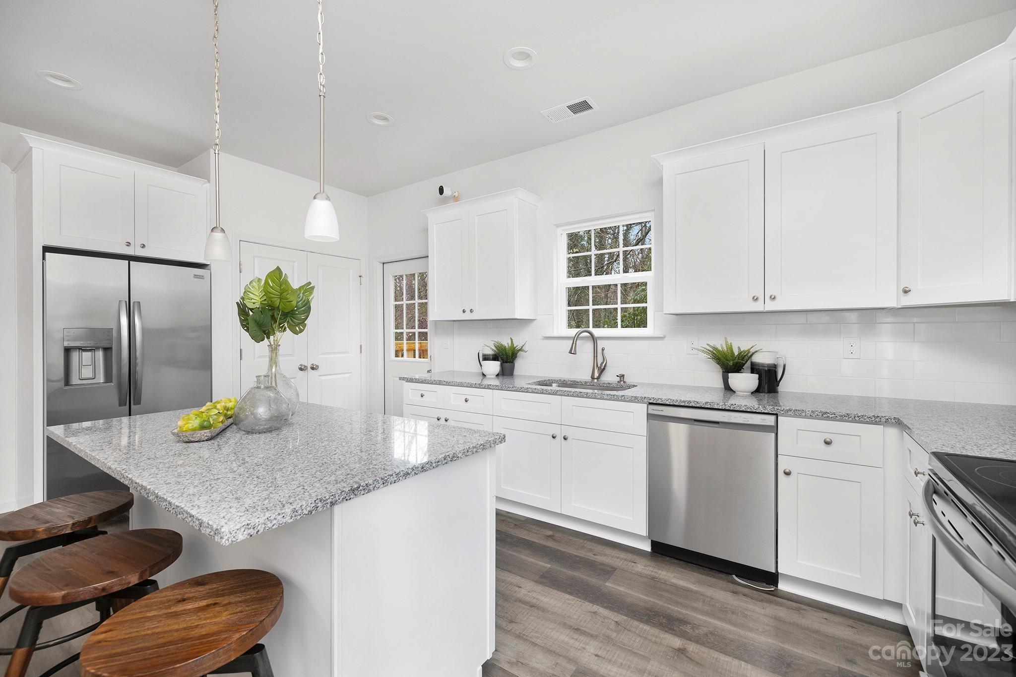 8725 Mt Holly Road Charlotte, NC 28214 - Photo 2 of 19 a kitchen with kitchen island granite countertop a white cabinets a sink appliances and cabinets