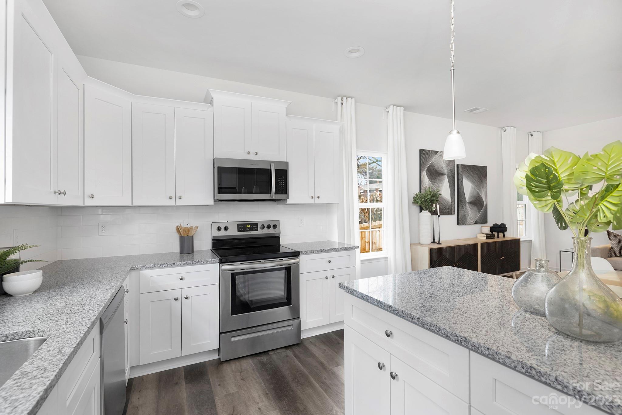 8725 Mt Holly Road Charlotte, NC 28214 - Photo 4 of 19 a kitchen with granite countertop white cabinets and stainless steel appliances