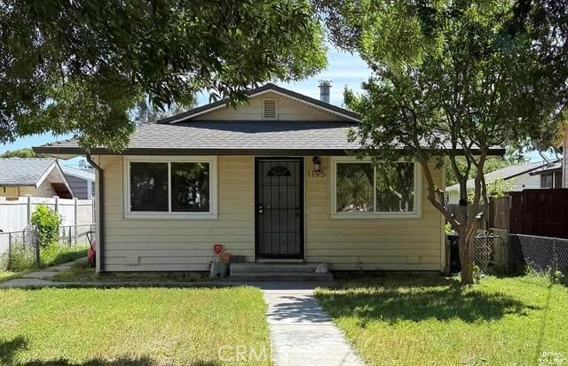 1195 West Street Corning, CA 96021 - Photo 1 of 11 a front view of a house with a yard