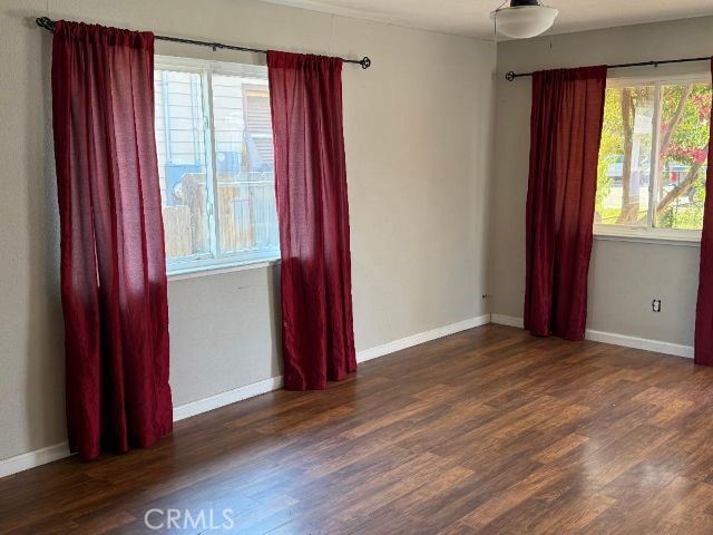 1195 West Street Corning, CA 96021 - Photo 3 of 11 a view of an empty room with wooden floor and a window