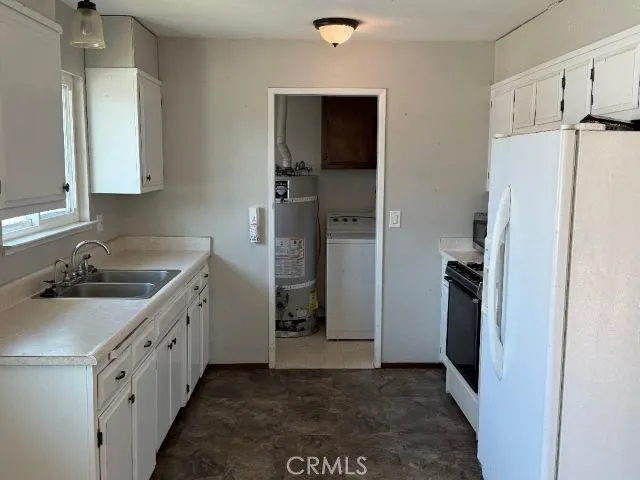 a kitchen with a sink and refrigerator