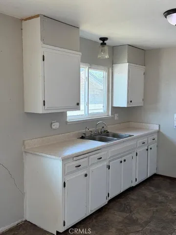 a kitchen with white cabinets