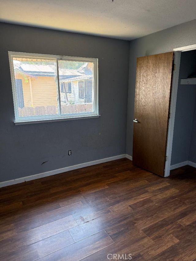 1195 West Street Corning, CA 96021 - Photo 9 of 11 a view of an empty room with wooden floor and a window