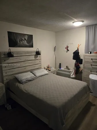 a bed sitting in a bedroom and mirror