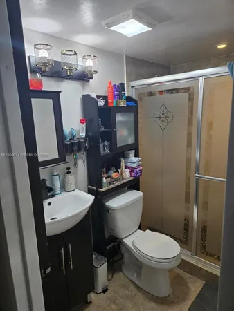 a bathroom with a sink toilet and a shower