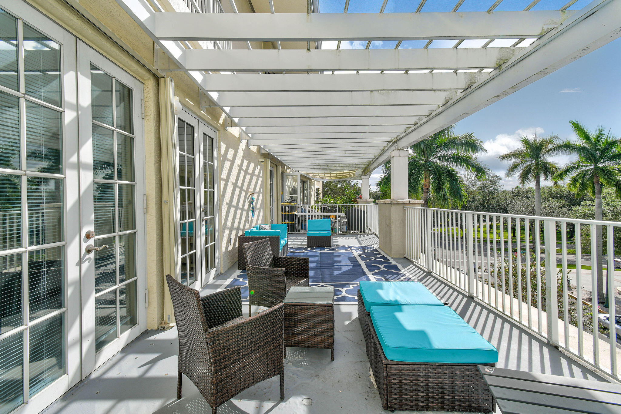 1200 Town Center Drive, Unit 326 Jupiter, FL 33458 - Photo 2 of 44 a view of a patio with couches chairs and wooden floor