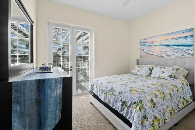 a bedroom with a bed and glass windows