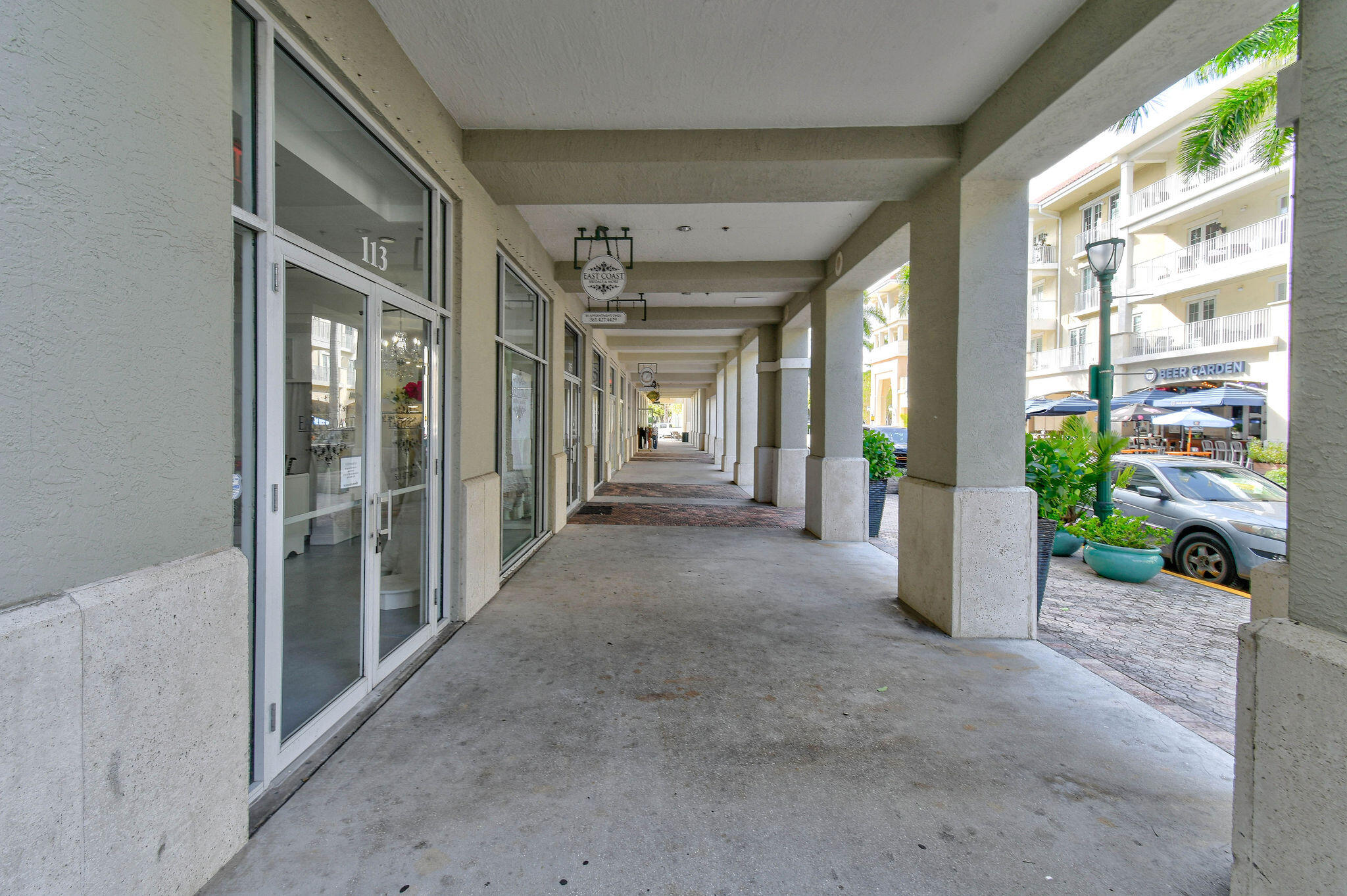 1200 Town Center Drive, Unit 326 Jupiter, FL 33458 - Photo 29 of 44 a view of a hallway with potted plants